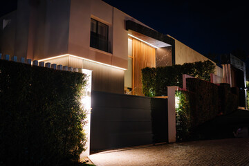 Sotogrande, Spain - January, 23, 2024 - A modern house at night, illuminated by exterior lights,...
