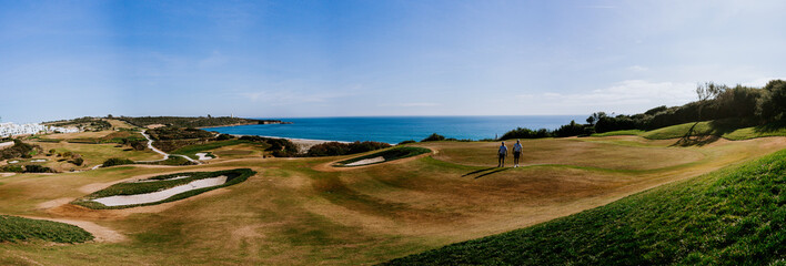 Sotogrande, Spain - January, 23, 2024 - A panoramic view of a golf course with golfers, sand traps,...