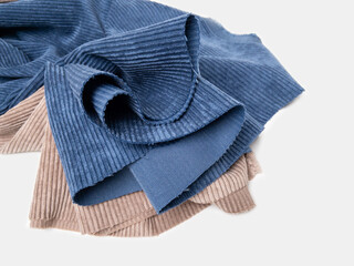 Multicolored fabrics folded in a stack . Multi-colored corduroy textile. Velvet.