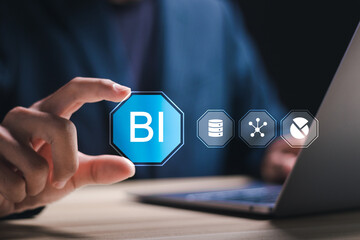 BI, Business Intelligence. Businessman using laptop with virtual screen of BI icon for technology to transform normal data into insights that can be used to help make decisions and analyze results