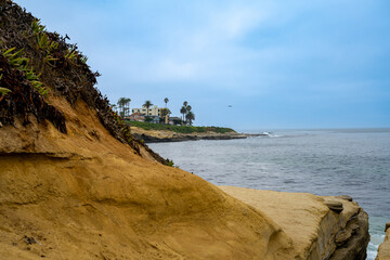 2023-12-31 A LOW ANGEL SHOT OF THE LA JOLLA SHORELINE WITH A CALM OCEAN AND A DARKER SKY IN LA JOLLA NEAR SAN DIEGO CALIFORNIA