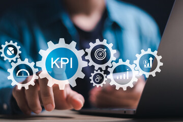 KPI Business analytics. Businessman use laptop with virtual icon of data analytics report and Key Performance Indicators on information dashboard for business strategy and business intelligence.