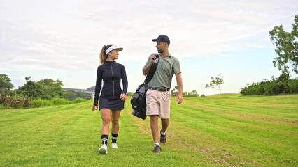 Sports Man and Athletic Woman Walk at Golf Course with Clubs and Balls in Bag. Happy Couple of Caucasian People Ready to Play Game with Putter. Modern Concept of Professional Male and Training Female - Powered by Adobe