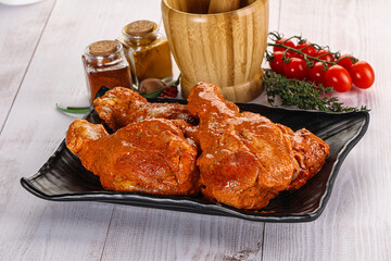 Raw turkey shoulder wing in Indian tandoori marinade