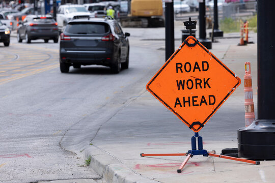 A public sign shows that Road Work is ahead.
