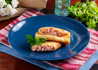 Pancakes with ham and cheese on the table, cafe, breakfast