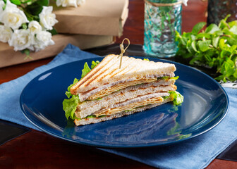 Sandwich with chicken and egg pancake on the table, cafe, breakfast