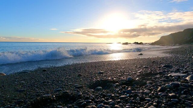 Idillic Beach waves on pebbles at golden hour and sunset Copper Coast Waterford Ireland natures beauty