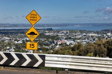 Sign speed ramps ahead. Traffic sign. Warning. View from the top of Mount Eden Auckland New Zealand. 15 miles an hour. - obrazy, fototapety, plakaty