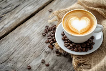 Tuinposter Coffee cup with heart shape latte art and coffee beans on old wood background with copy space © ttonaorh