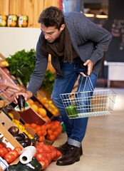 Healthy food, search and man shopping at a supermarket for grocery promotions, sale or discounts...