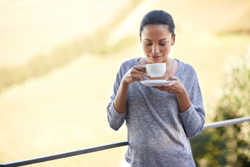 Woman, coffee and relax on balcony outdoor, aroma and warm beverage with morning routine and zen in nature. Peace, mockup and espresso for caffeine or happiness with smile and tea cup in countryside