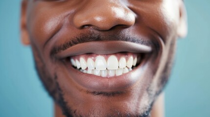 Cropped shot of a young African smiling man. Teeth whitening. Dentistry, dental treatment.
