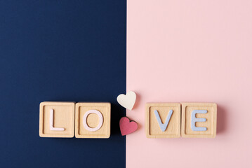 Expressing Affection: ‘LOVE U’ with Wooden Blocks and Hearts over  dual-colored background
