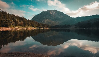 Fototapeta na wymiar Mirror of Tranquility: Calm Waters Reflect the Majestic Mountain, Offering a Scenic Water Mirror and Idyllic Lake Serenity. Generative AI