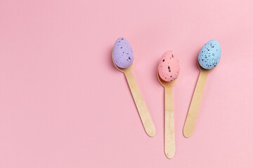 Colored Easter eggs with the wooden spoons.