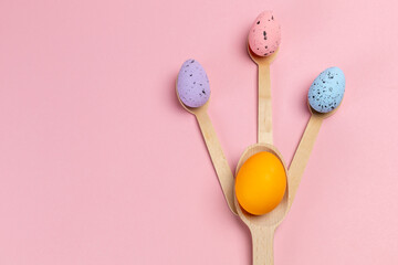 Colored Easter eggs with the wooden spoons.