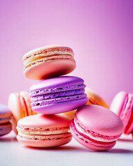 Stack of colorful french macaroons on light violet background, close up.