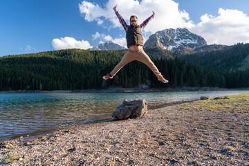happy man jumps for joy being in nature