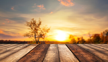 Fototapeta na wymiar Wood table in autumn landscape with empty copy space for product display. and a golden sunset sky