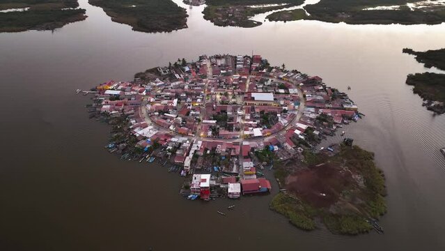 Drone approaching the Mexcaltitan Village, colorful dusk in Nayarit, Mexico