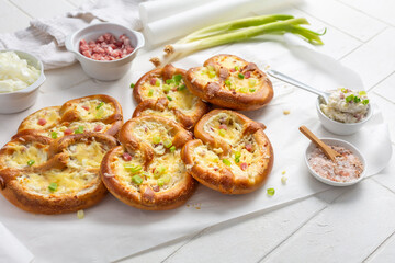 Homemade delicious traditional Bavarian Brezeln or pretzels baked with cream cheese, bacon and onions