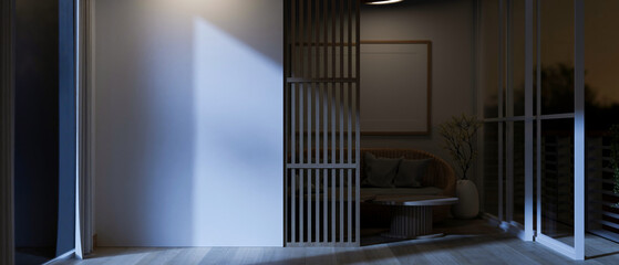 Interior design of a modern, minimalist living room at night with a white mockup wall and a balcony.