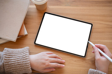 Top view image of a woman using a digital tablet at her desk. people and technology concepts