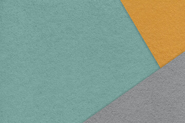 Fototapeta premium Texture of craft cyan color paper background with orange and gray border. Vintage abstract green cardboard