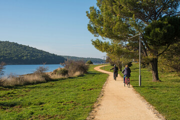 Cyclists on a footpath on Vizula Peninsula in Medulin, Istria, Croatia. December
