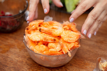 Hands and hot shrimp with smoke.