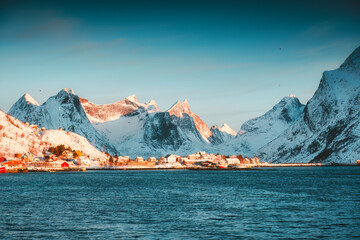 Winter wonderland of Reine town fishing village with fjord mountain in the morning at Lofoten...