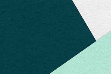 Texture of craft dark emerald color paper background with white, green and mint border. Vintage...