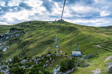 Chairlift or cable car riding over Stoos village and mountain landscape at Schwyz, Switzerland