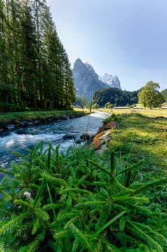 Rusenlaui with wellhorn swiss alps and Reichenbach river flowing in summer on sunny day at Switzerland