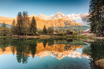 Lac des Gaillands with Mont Blanc massif and train at station in the sunset at Chamonix, France - obrazy, fototapety, plakaty