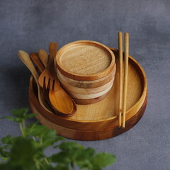 photo display of handmade wooden tableware. consisting of plates, coasters, spoons, forks and chopsticks. isolated background