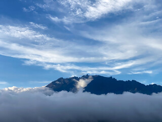 Majestic Mount Kinabalu with sky and fog background, at sunset after a light rain.