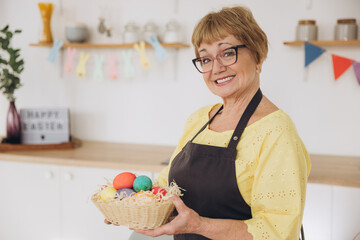 Happy Easter! Cute retired old woman painted easter egg. DIY craft easter eggs