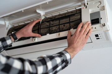 Air conditioner filter dusty. Preparation for maintenance and cleaning