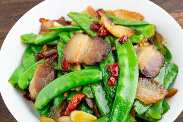 A plate of fried peas and bacon