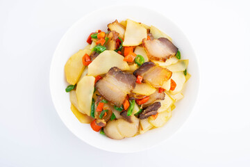 A dish of stir-fried bacon with mustard greens