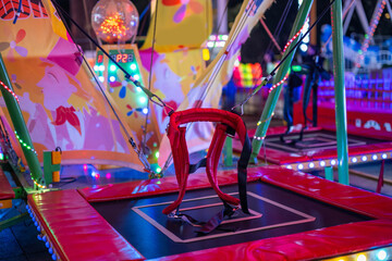 Bounce bed in amusement park at night