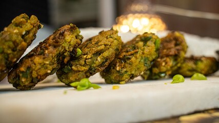 Hara bhara Kabab or Kebab is Indian vegetarian snack on white table, selective focus