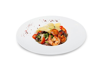 Caesar salad with shrimp on a plate, isolated