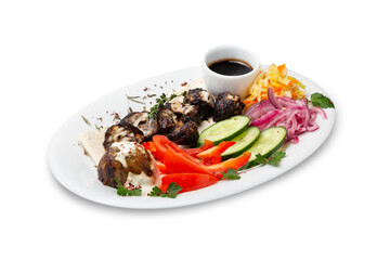Lamb liver shashlik with fresh vegetables on a plate, isolated