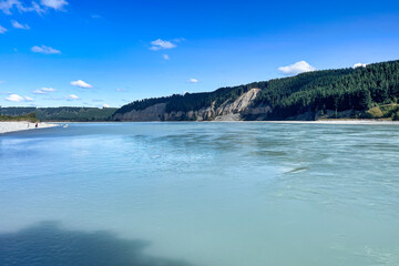 The clean turquoise blue water in the river as it flows under the bridge at the Rakaia Gorge