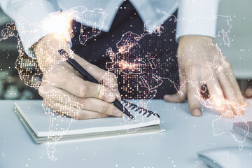 Multi exposure of abstract graphic world map and hand writing in diary on background with laptop, big data and networking concept