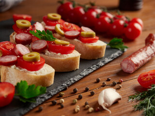 Bruschetta with tomatoes, mozzarella cheese and basil on a cutting board. Traditional italian appetizer or snack, antipasto. Top view with copy space.     