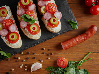 Bruschetta with tomatoes, mozzarella cheese and basil on a cutting board. Traditional italian appetizer or snack, antipasto. Top view with copy space.     